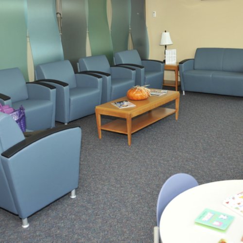 Waiting room with dark grey carpet flooring