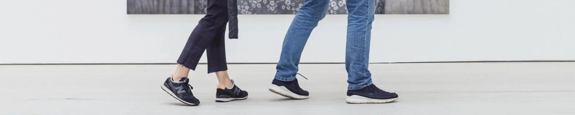 Customers walking in a bright commercial space with white flooring